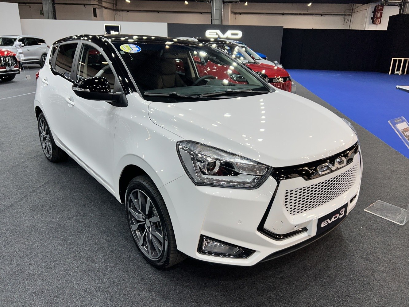 Front angled view with LED headlights, black roof, and alloy wheels