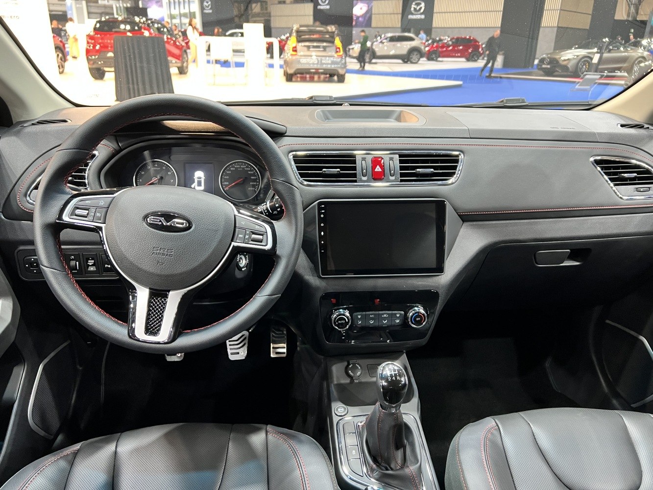 Steering wheel, dashboard, and manual gear shifter in car interior