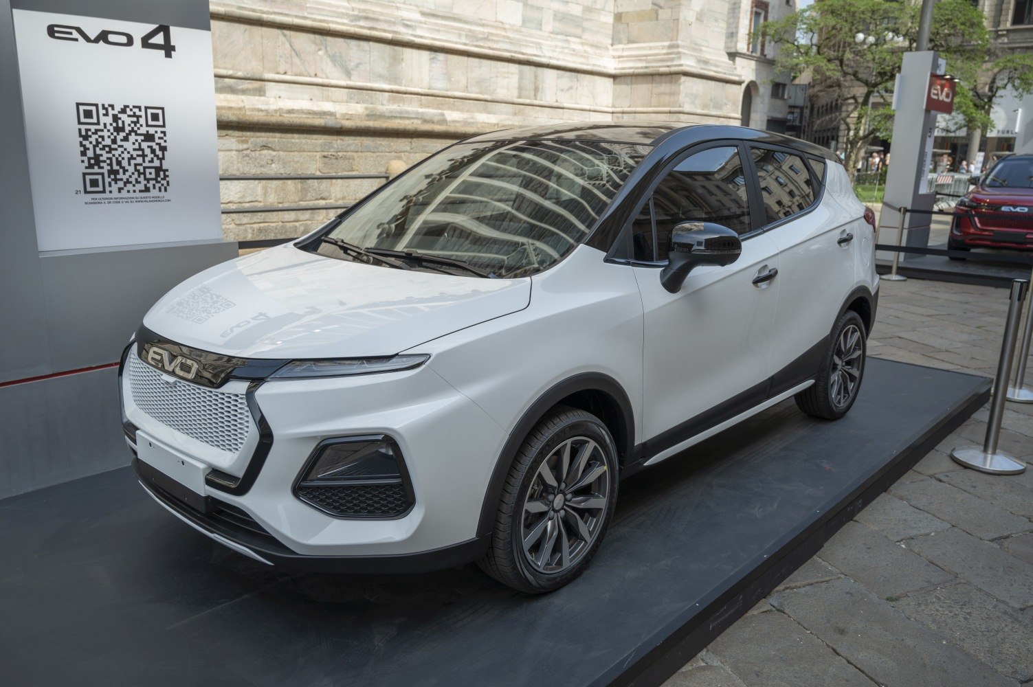 White SUV front three-quarter view with black roof and sleek grille