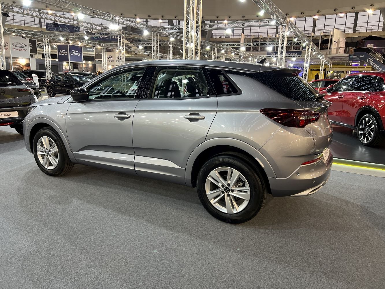 Side profile of silver SUV showcasing sporty rear design and sleek lines