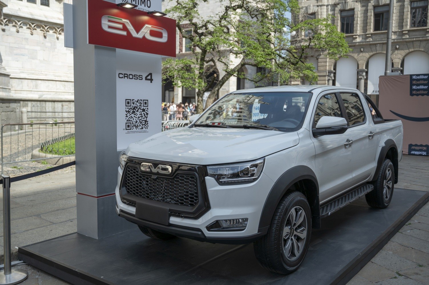 Modern white dual cab pickup truck with robust front grille and alloy wheels