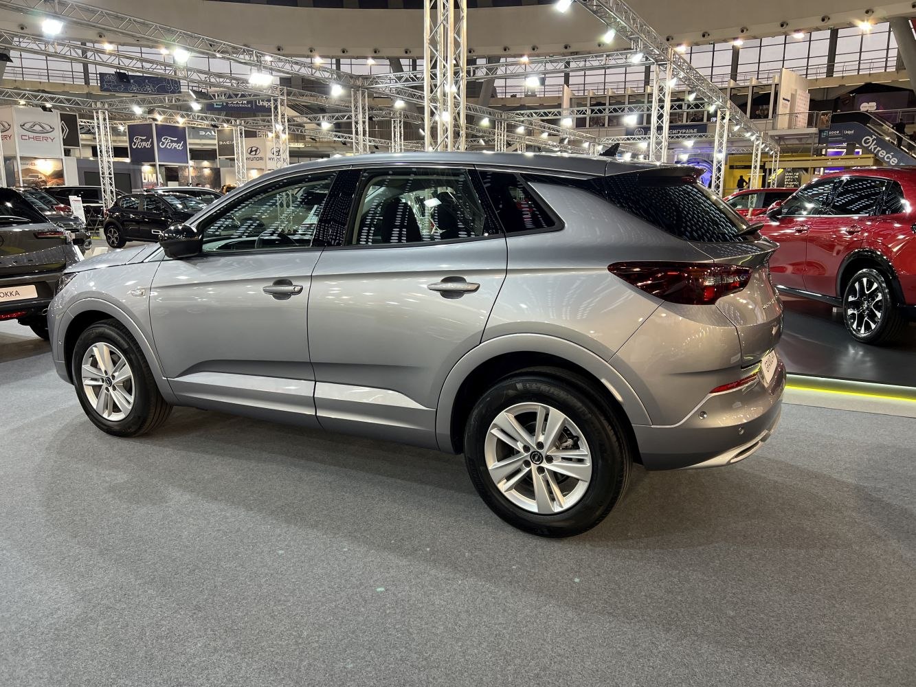Silver modern compact SUV side view with sleek styling and sharp lines