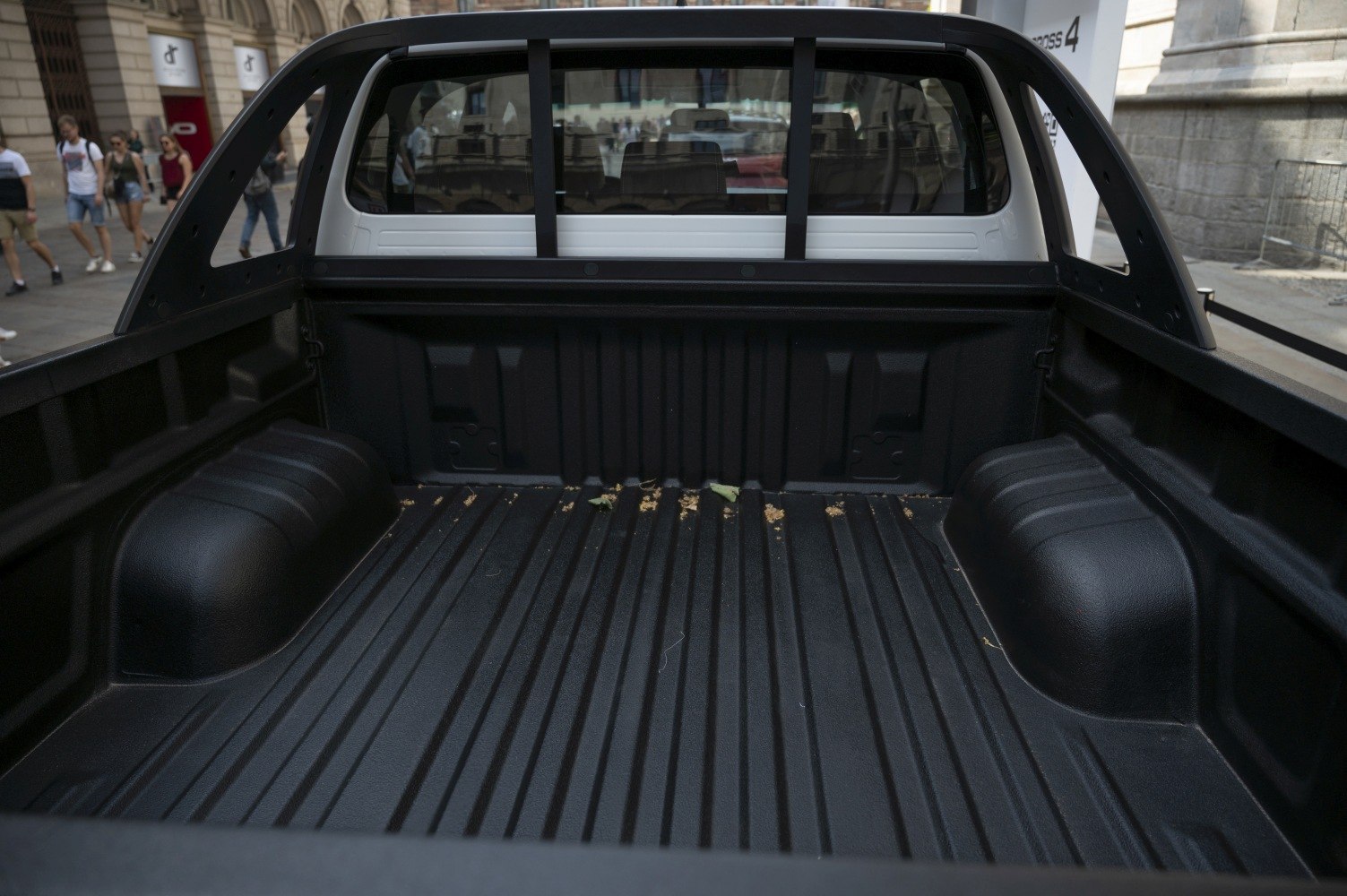 Pickup truck bed with protective liner and reinforced roll bar