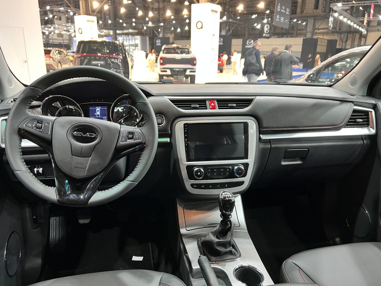Steering wheel, dashboard with touchscreen, manual gear shift in car interior