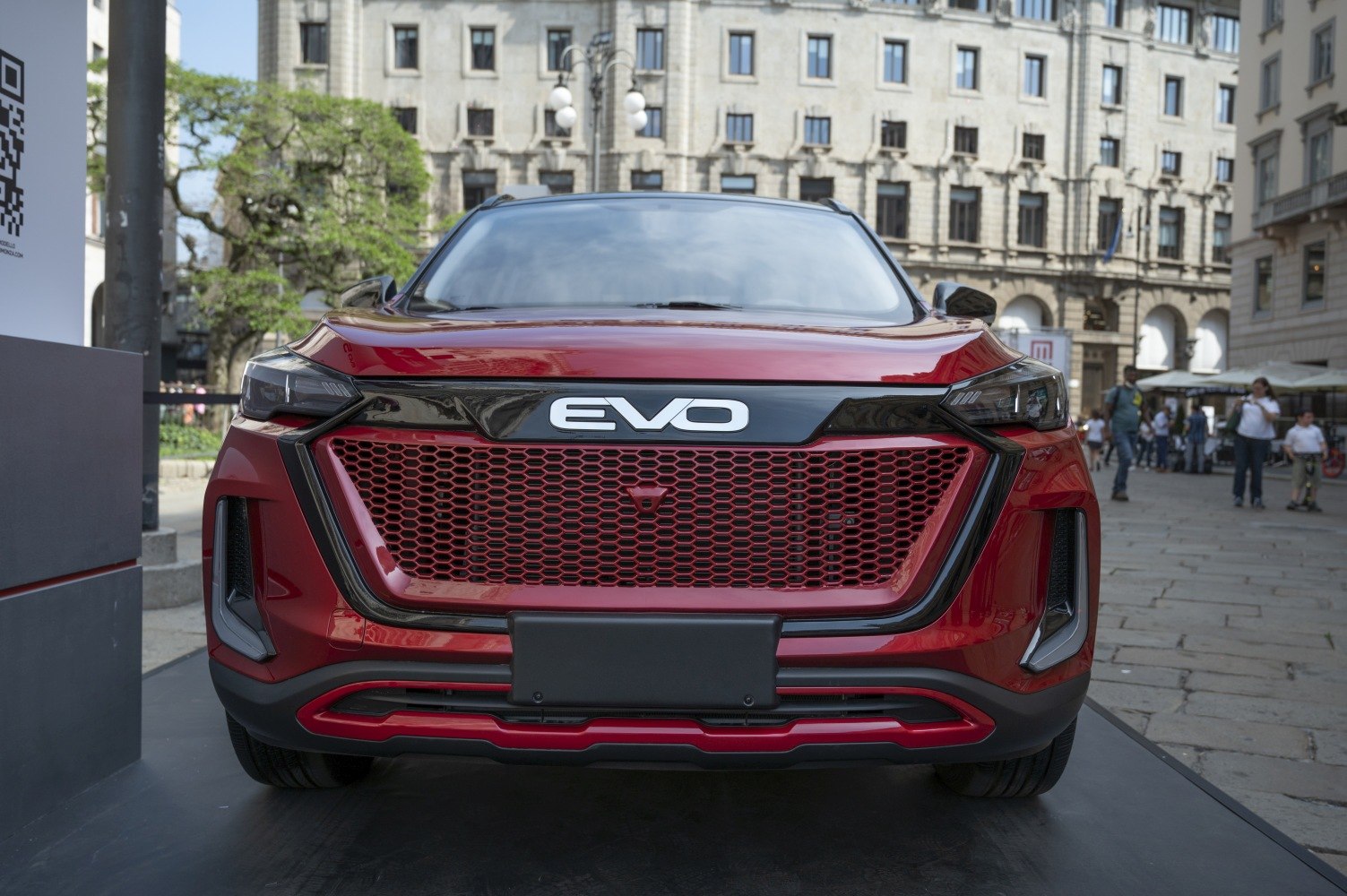 Front view of red SUV with honeycomb grille and LED headlights