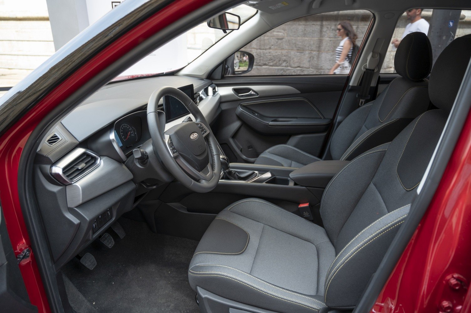 Ergonomic seats and modern dashboard with digital instrument cluster.