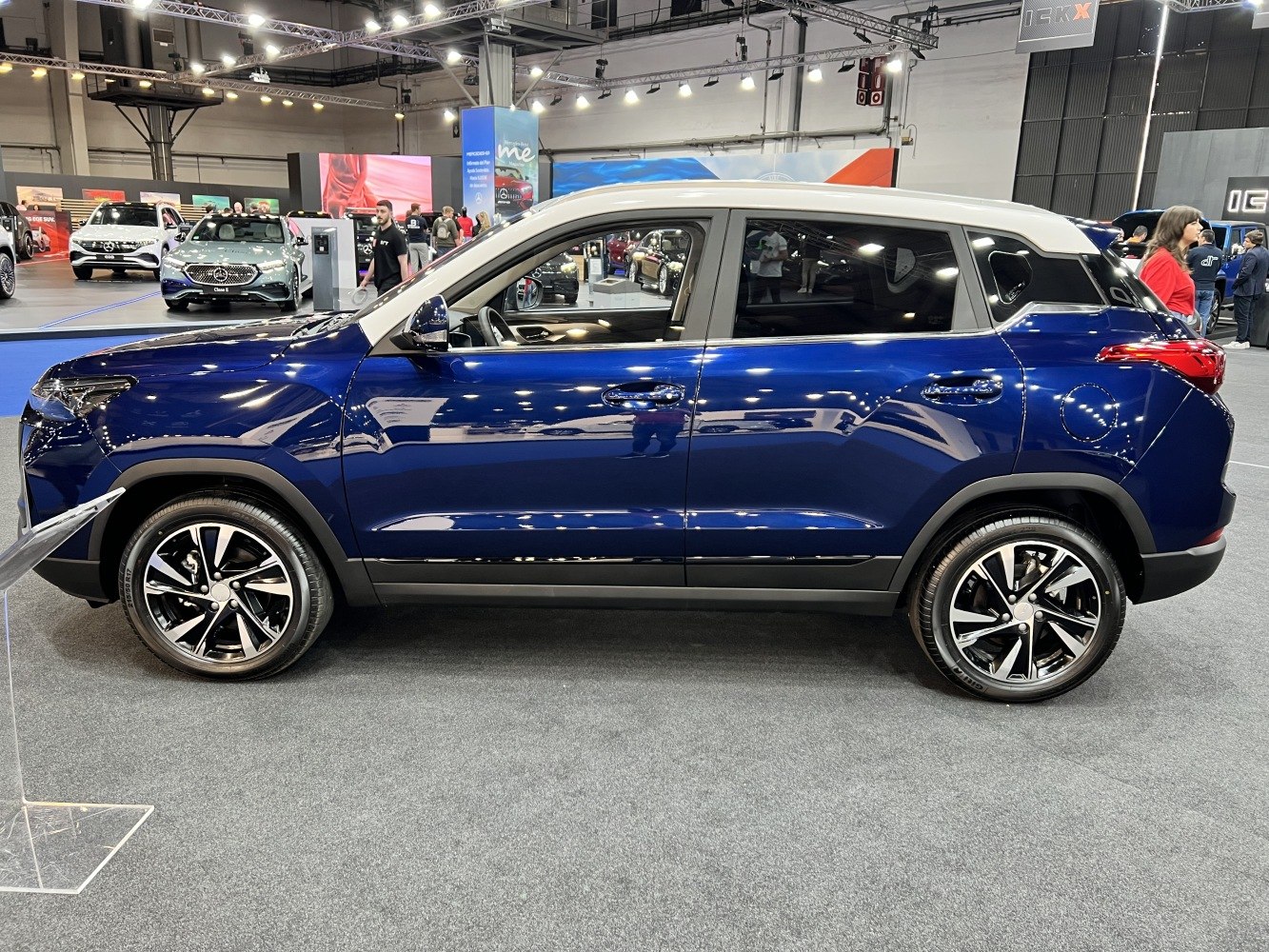 Blue SUV with contrasting white roof and alloy wheels side profile
