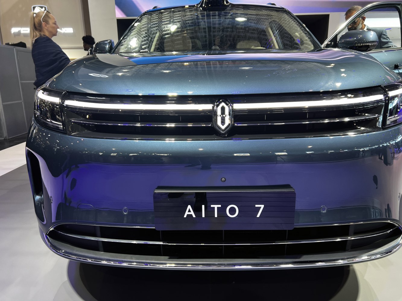 Front grille with integrated LED headlights and illuminated emblem