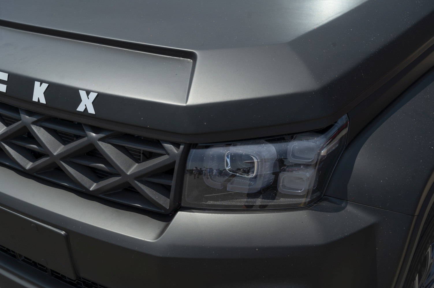 Close-up of front grille and headlight design with angular lines and integrated LEDs