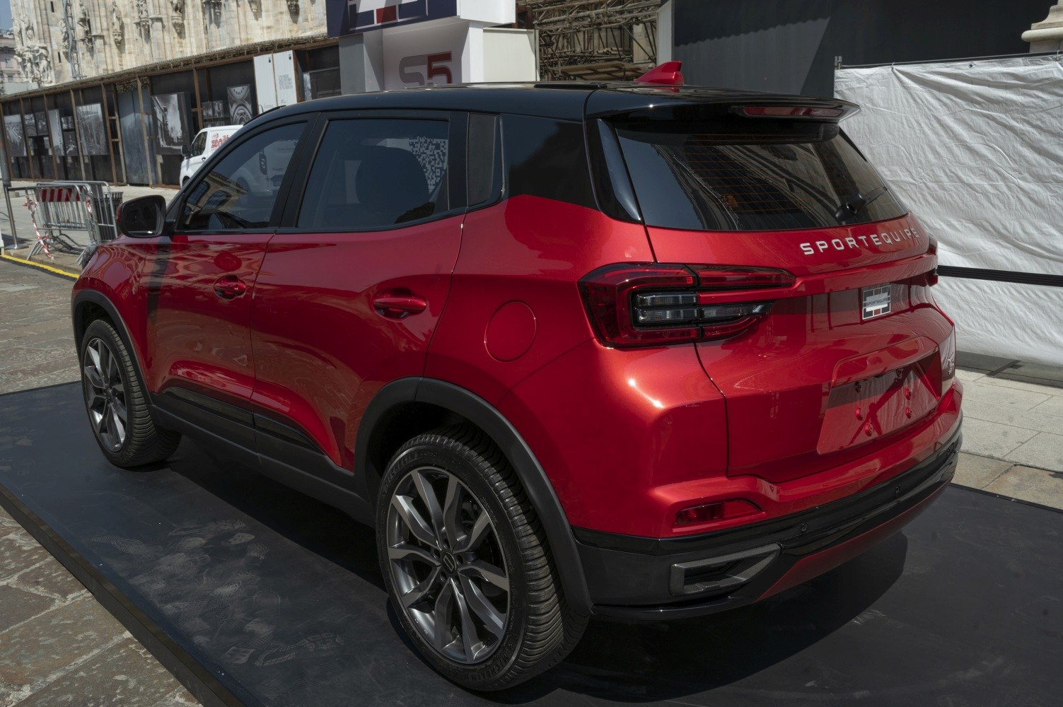 Red SUV rear and side view with black roof and alloy wheels