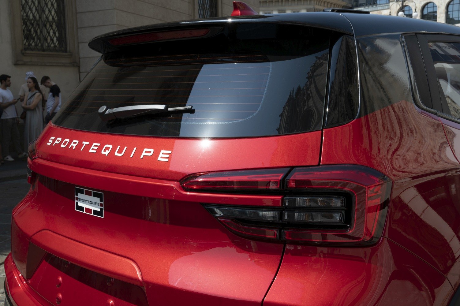 Red SUV rear with modern tail lights and rear windshield wiper