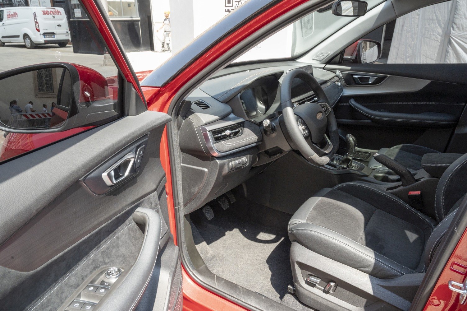 Modern dashboard and leather driver seat interior with steering controls