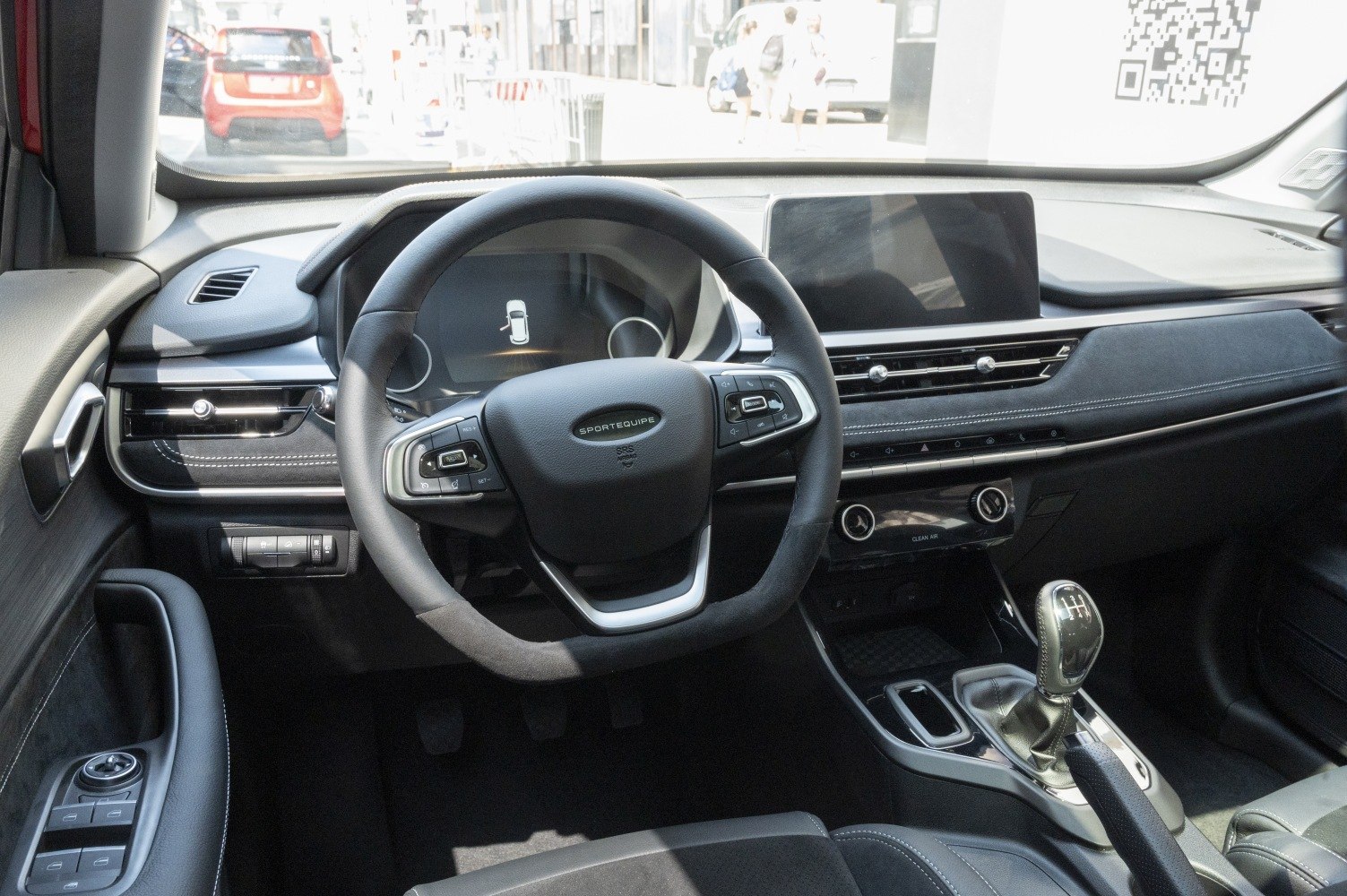 Modern car interior with steering wheel and manual gear shift