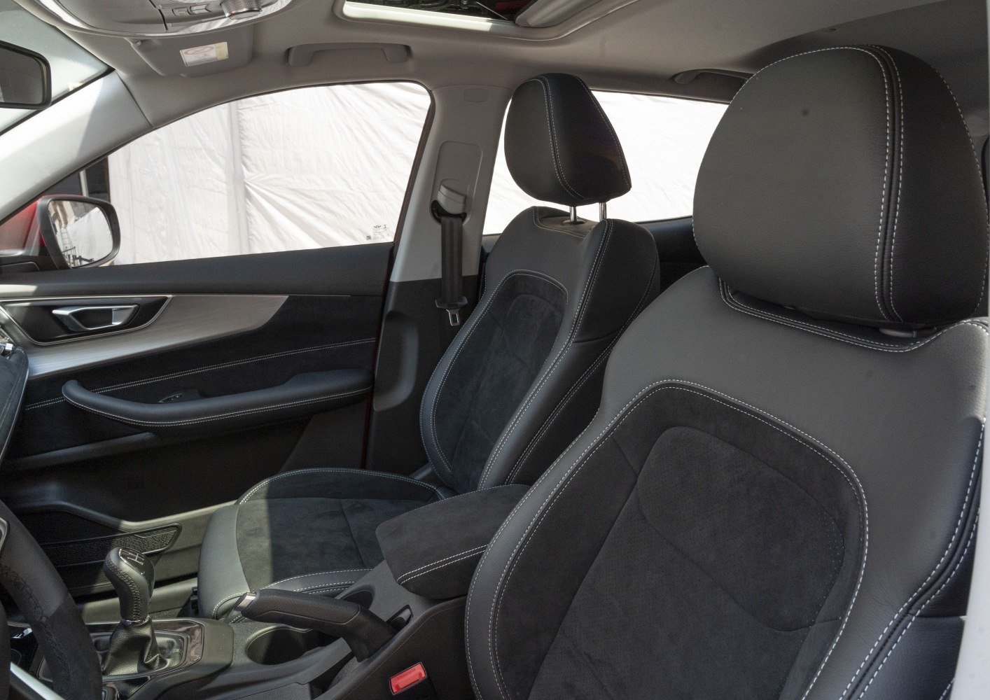 Black leather and suede front seats with white stitching and door panel