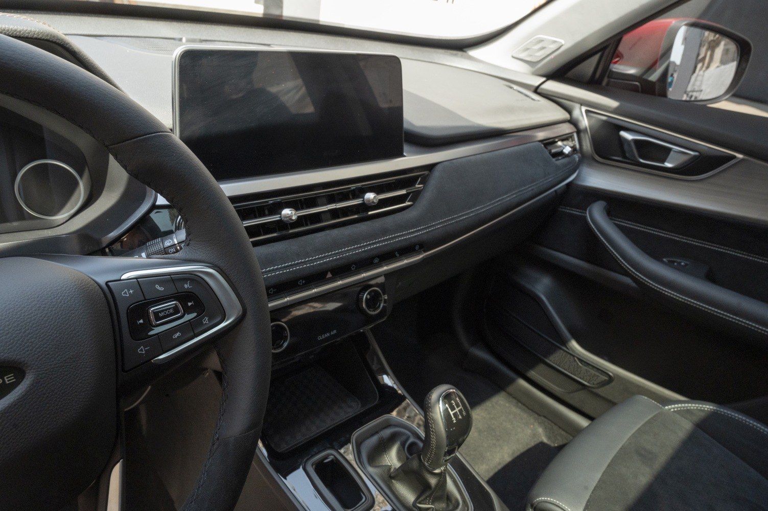 Manual gearbox, touchscreen display, and modern car interior design
