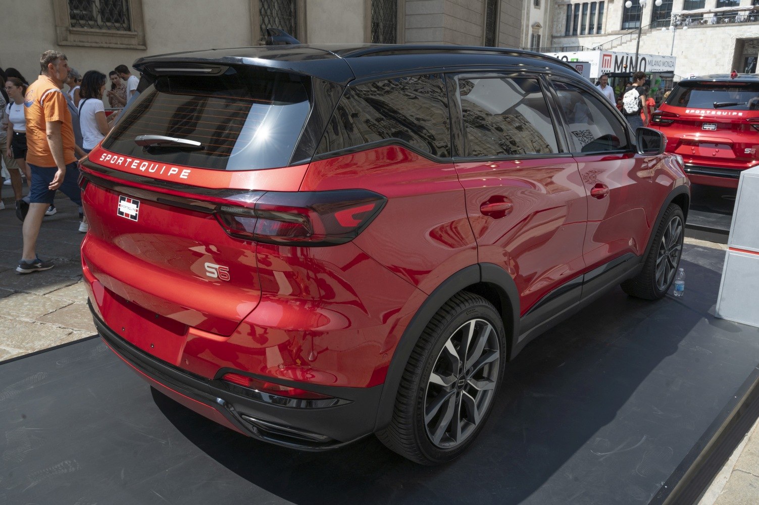 Rear and side view of red SUV with black roof and modern taillights