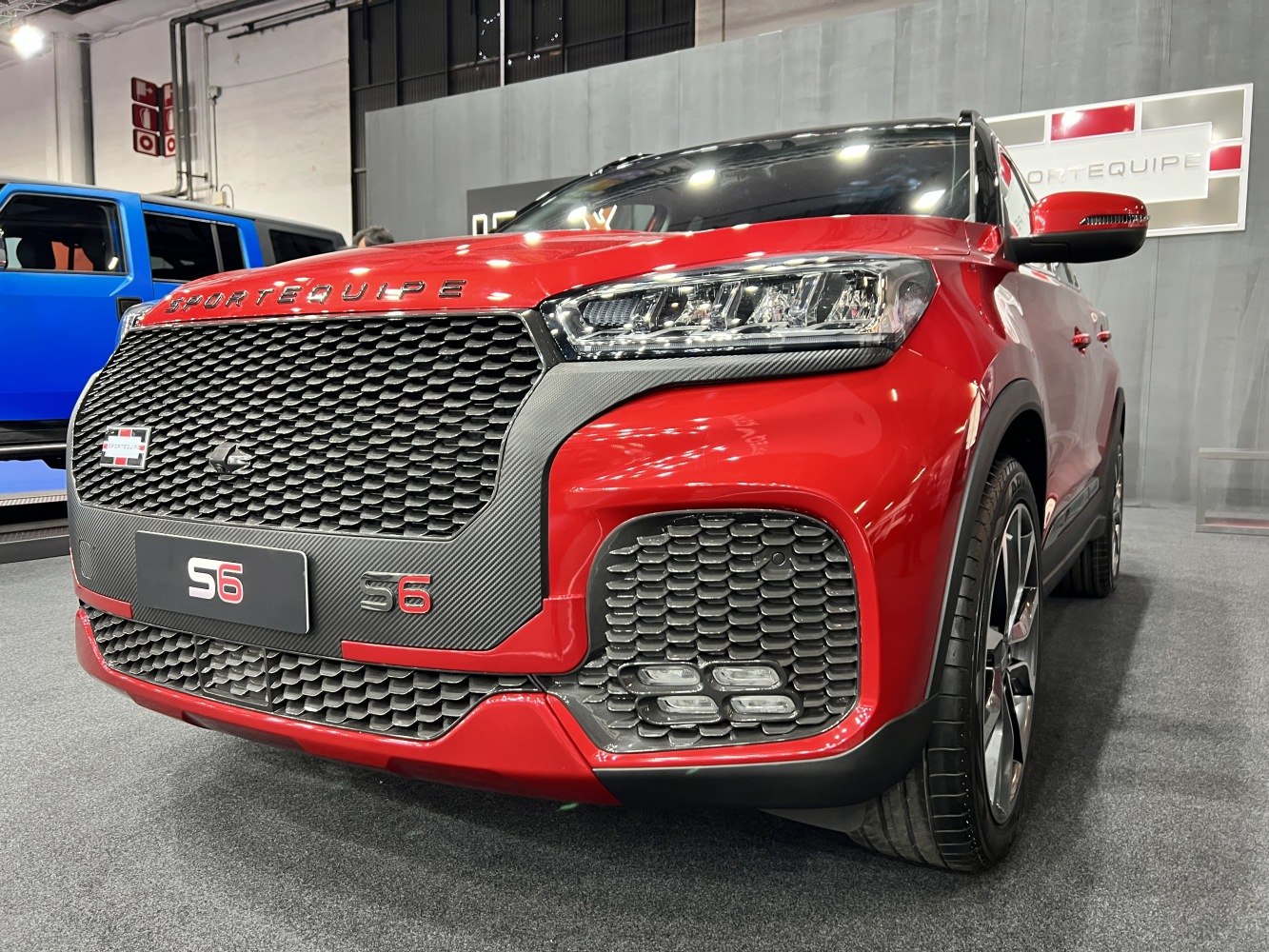 Front grille with carbon fiber accents and LED headlights on red SUV