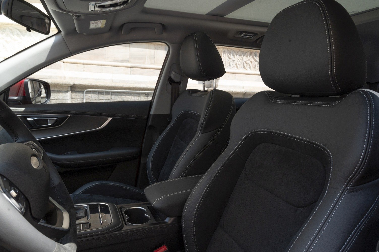 Black leather and fabric front seats with detailed stitching and center console