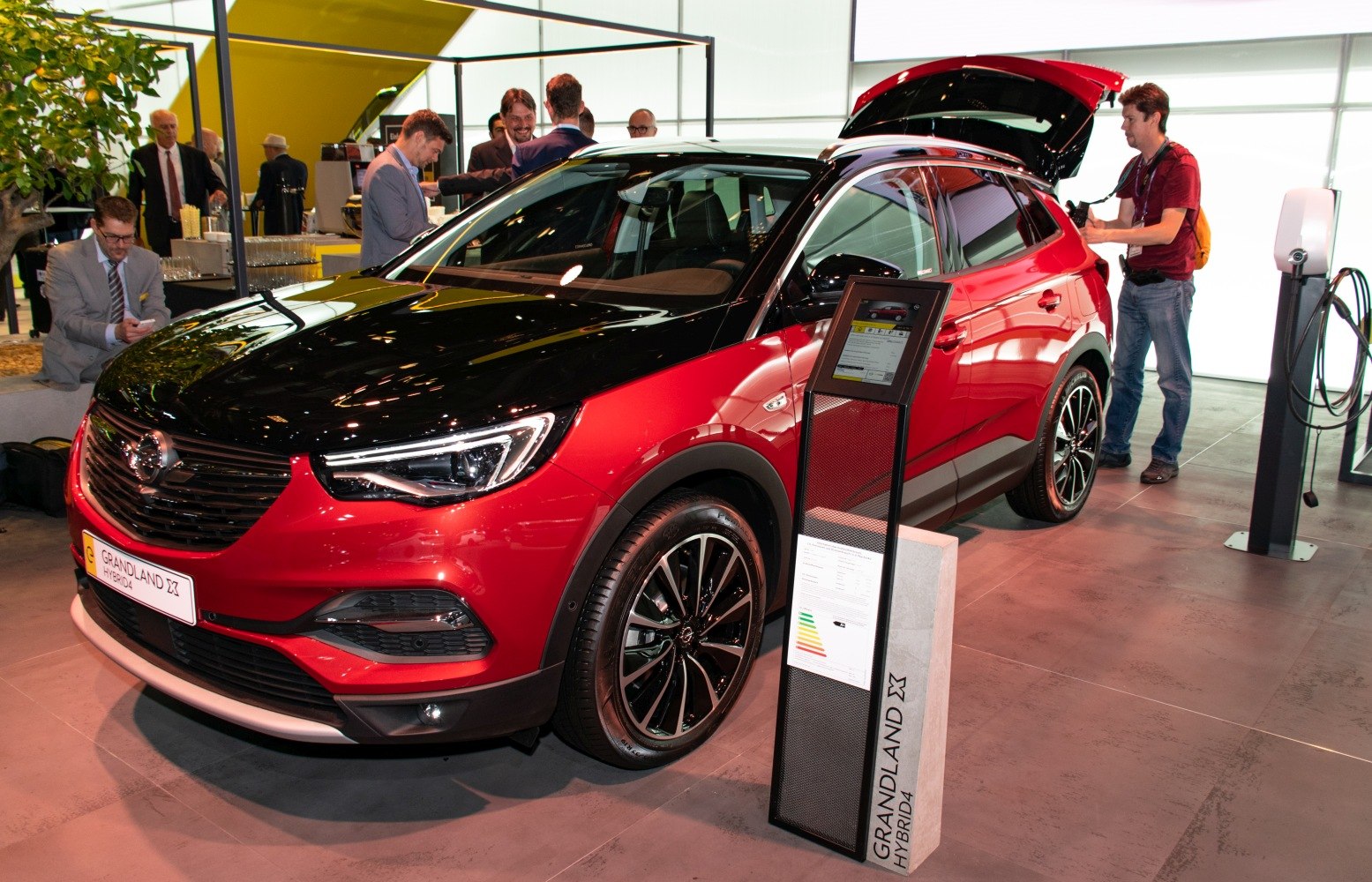 Red and black two-tone hybrid SUV front and side view with alloy wheels