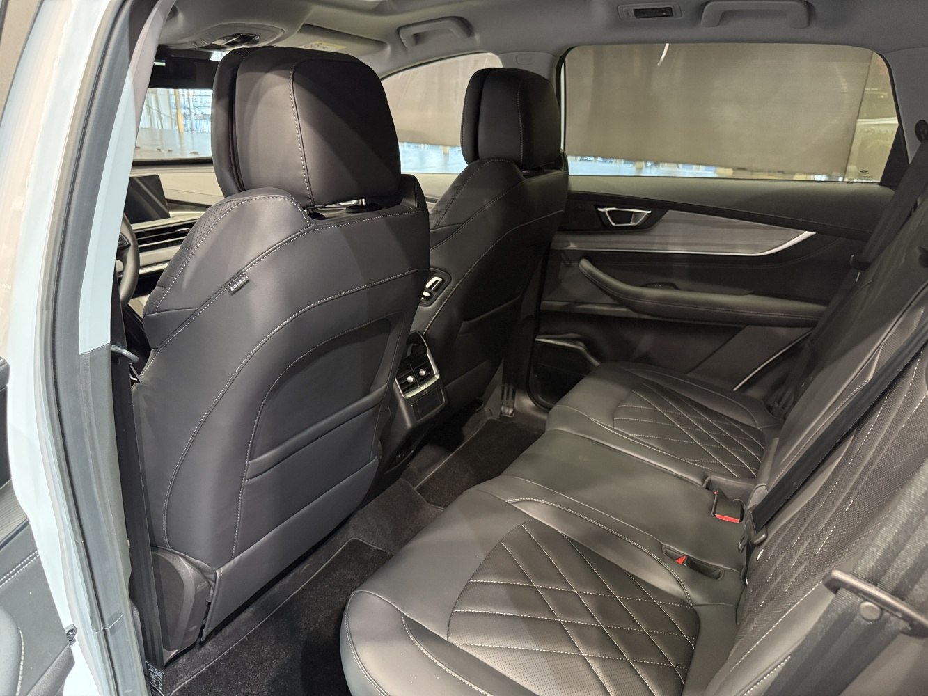 Black leather rear seats with diamond stitching and modern rear console