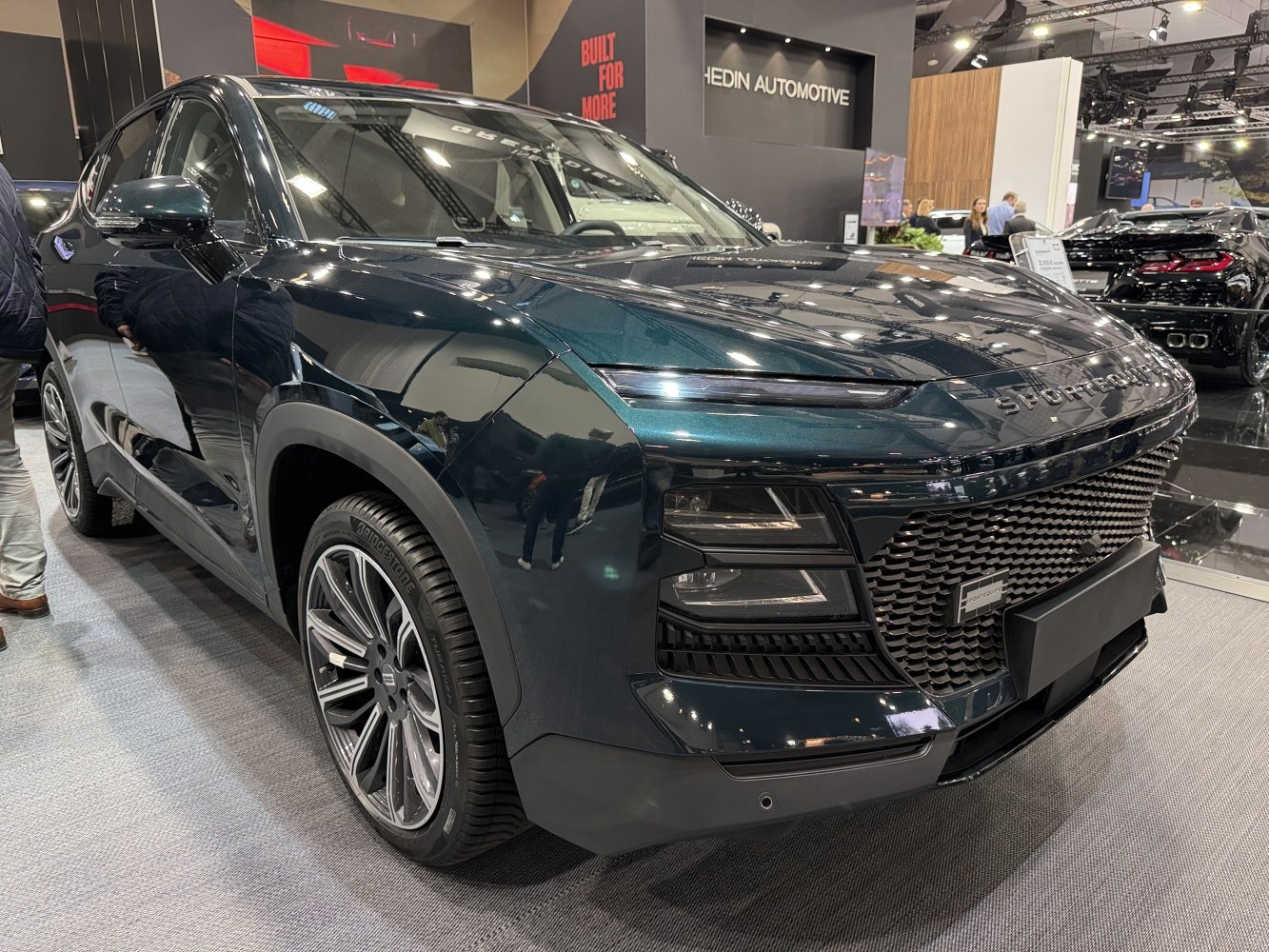 Slim LED headlights and bold mesh grille in front-angle view