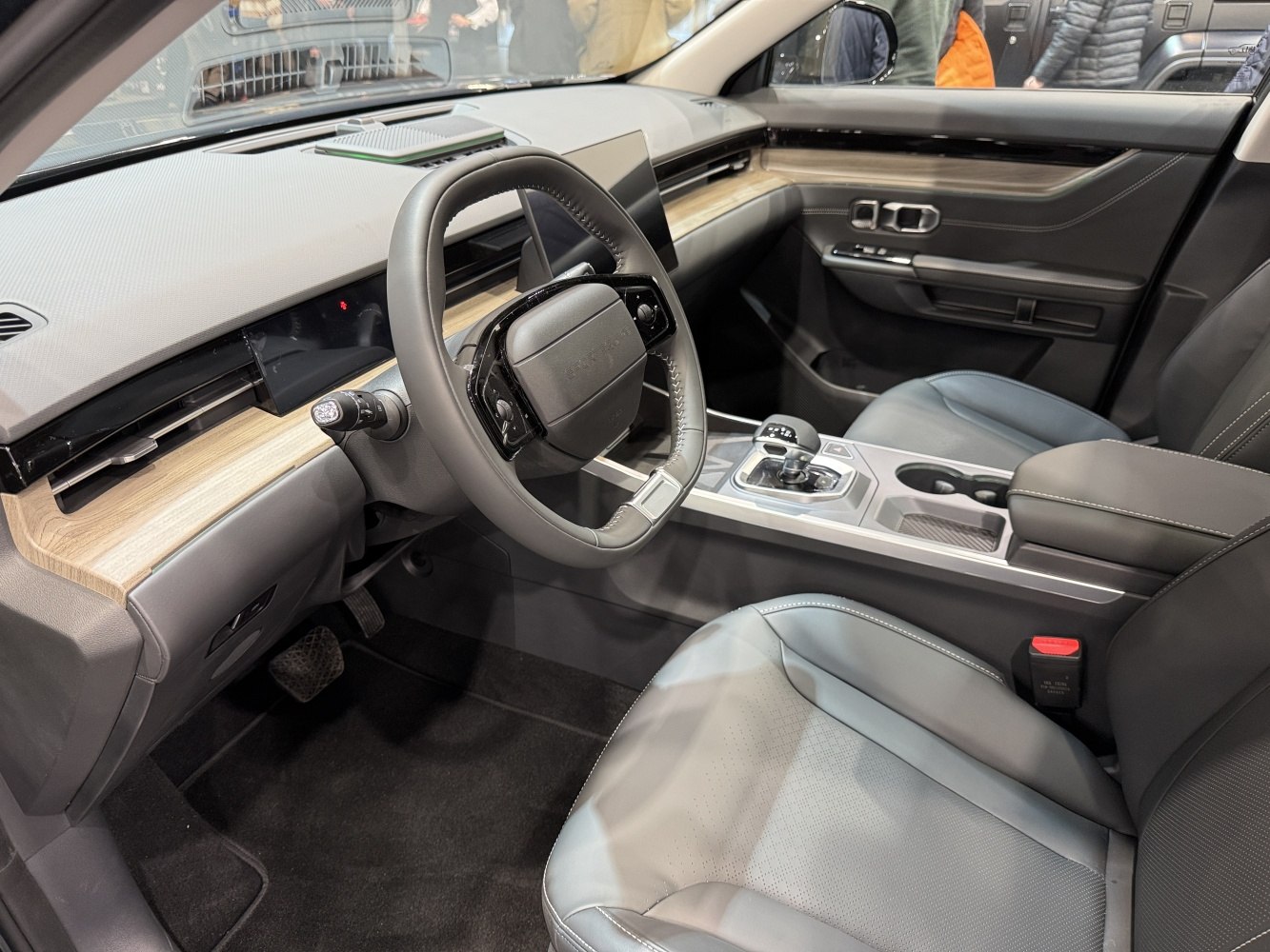 Modern car interior with digital dashboard and wood trim