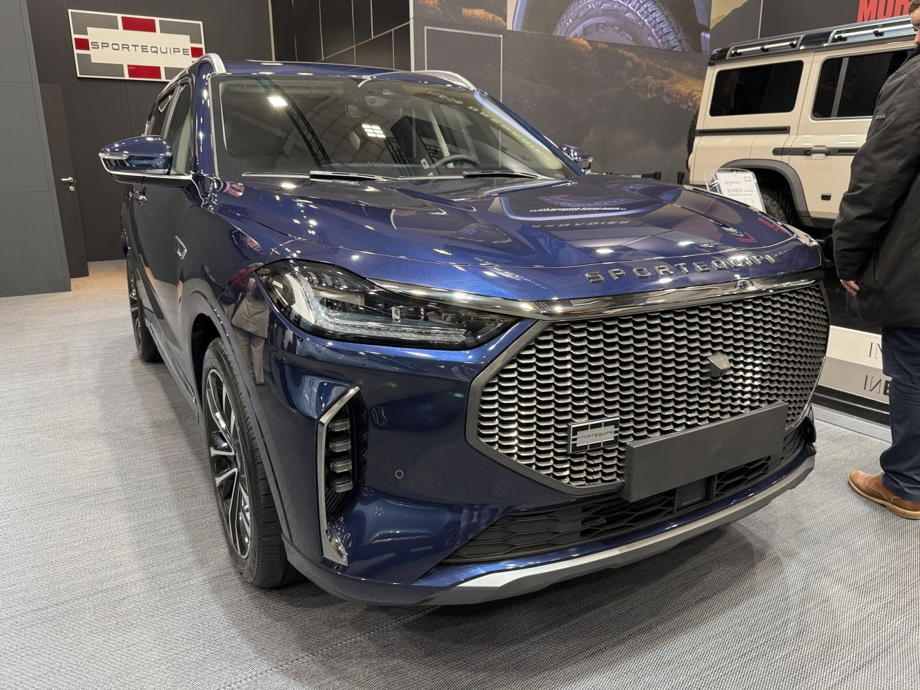 Large mesh front grille and sleek LED headlights of a modern SUV.