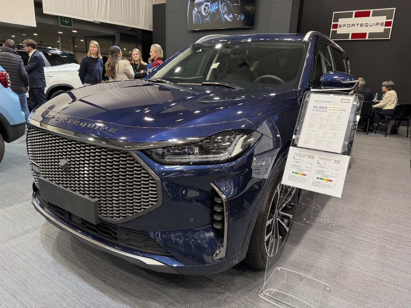 Large front grille with hexagonal pattern and sleek LED headlights
