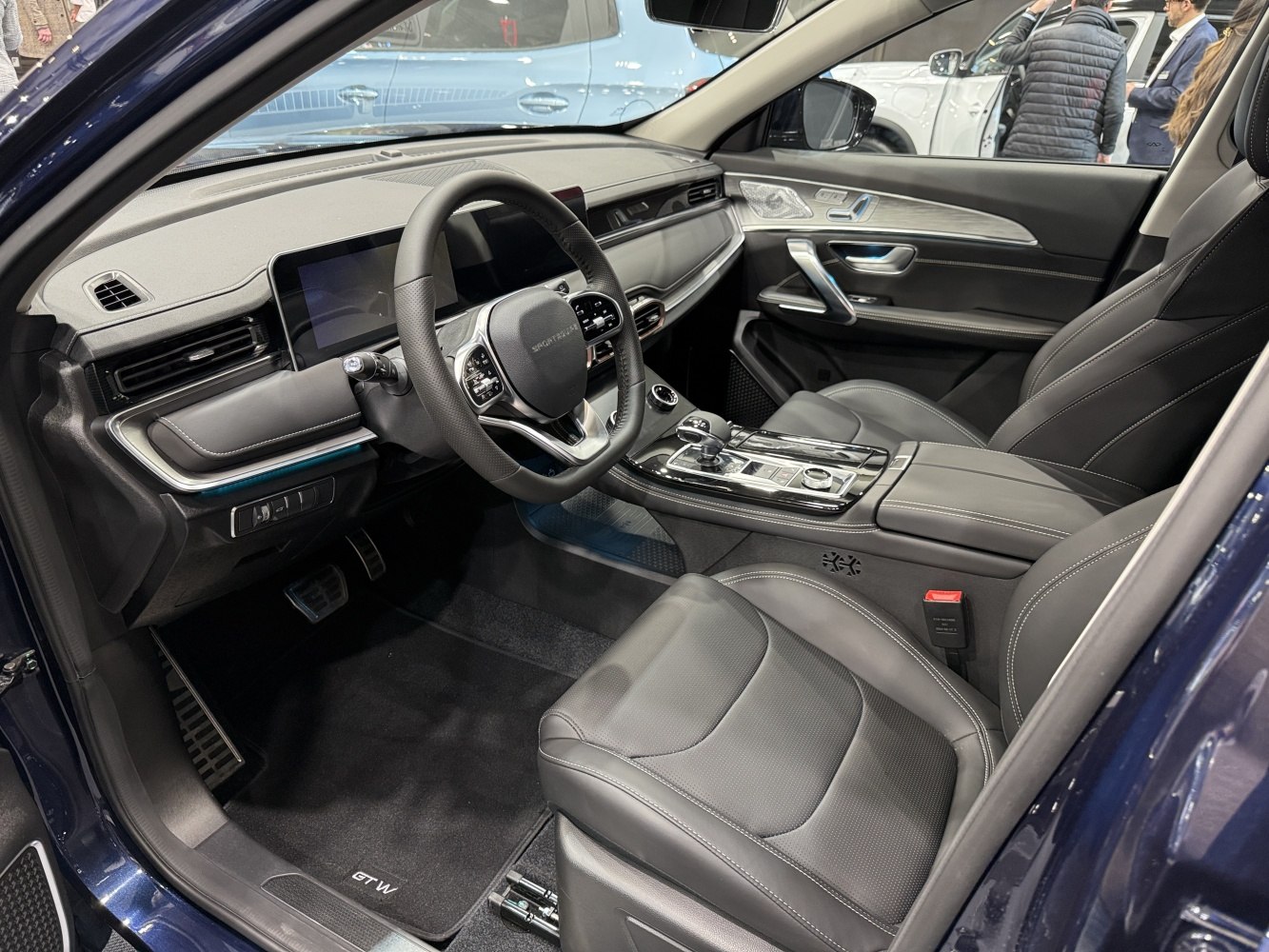 Modern luxury car interior with dashboard, steering wheel, and premium seats