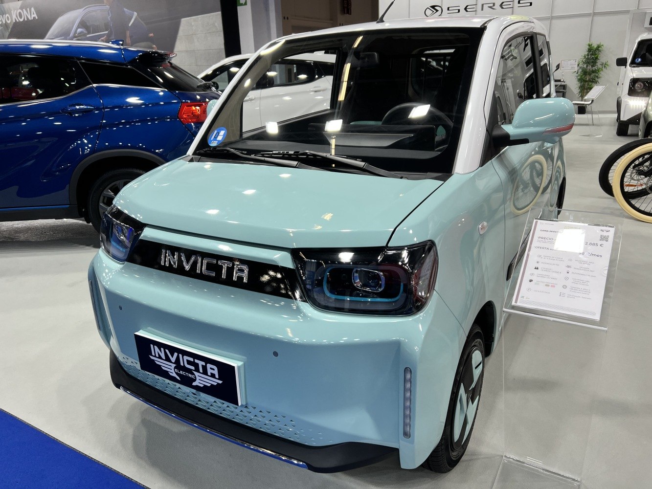 Compact electric vehicle with distinctive LED headlights and bold front grille design