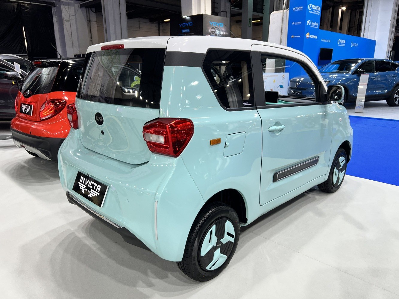 Compact electric microcar rear with angular tail lights and futuristic wheel design