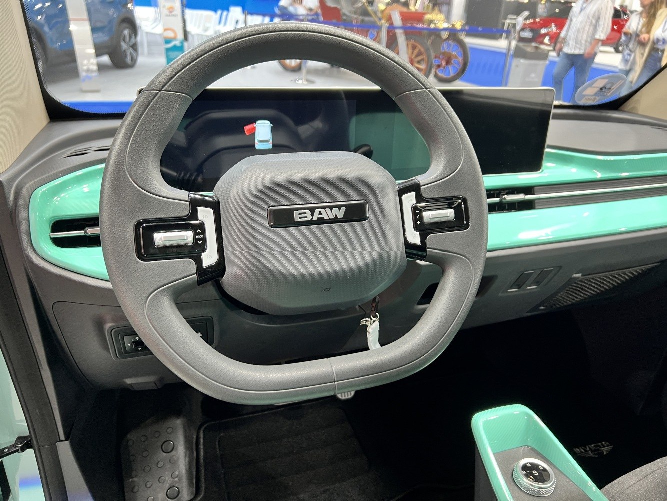 Steering wheel with integrated controls and digital dashboard in mint green trim