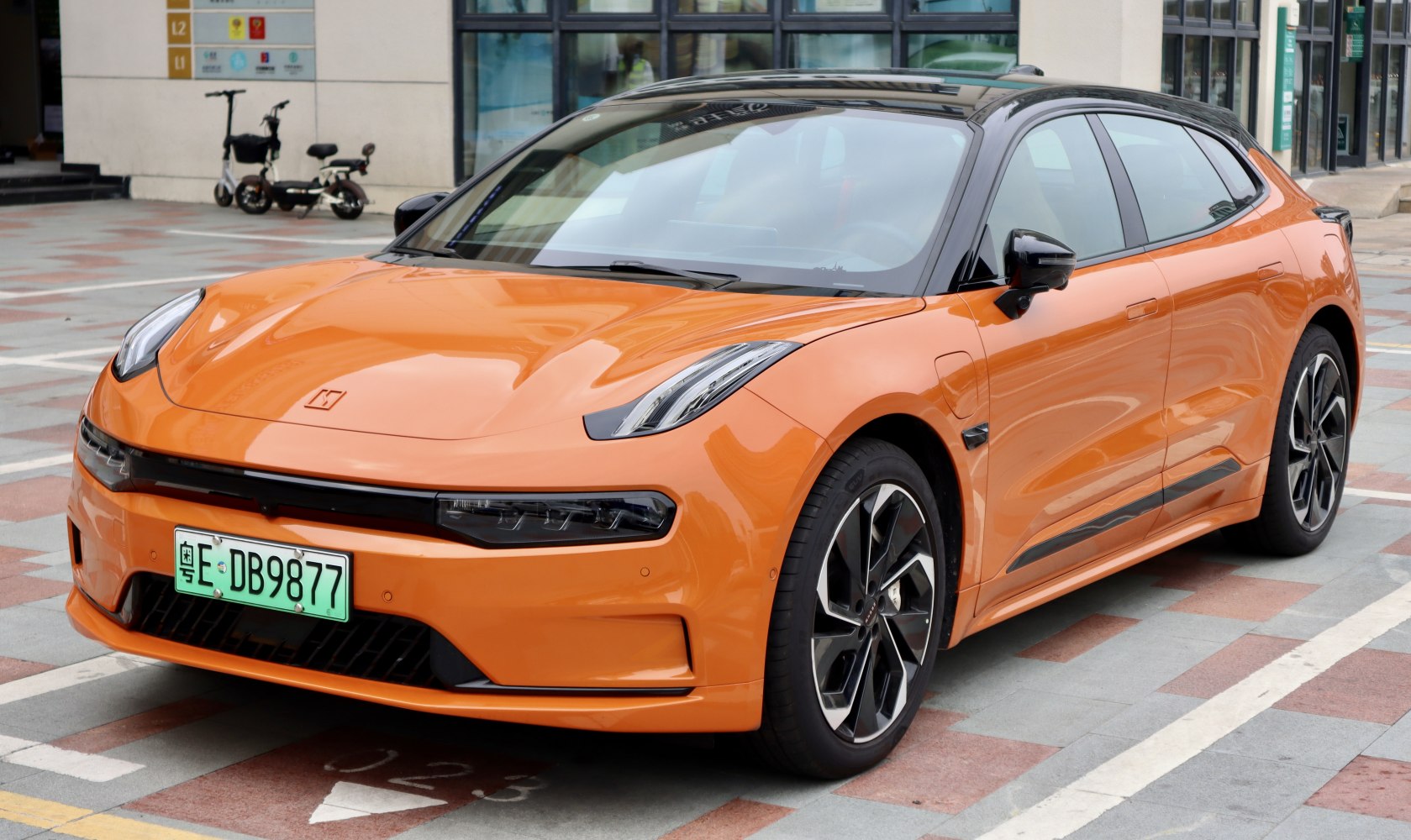 Sleek modern electric sedan with distinctive LED headlights and two-tone design.