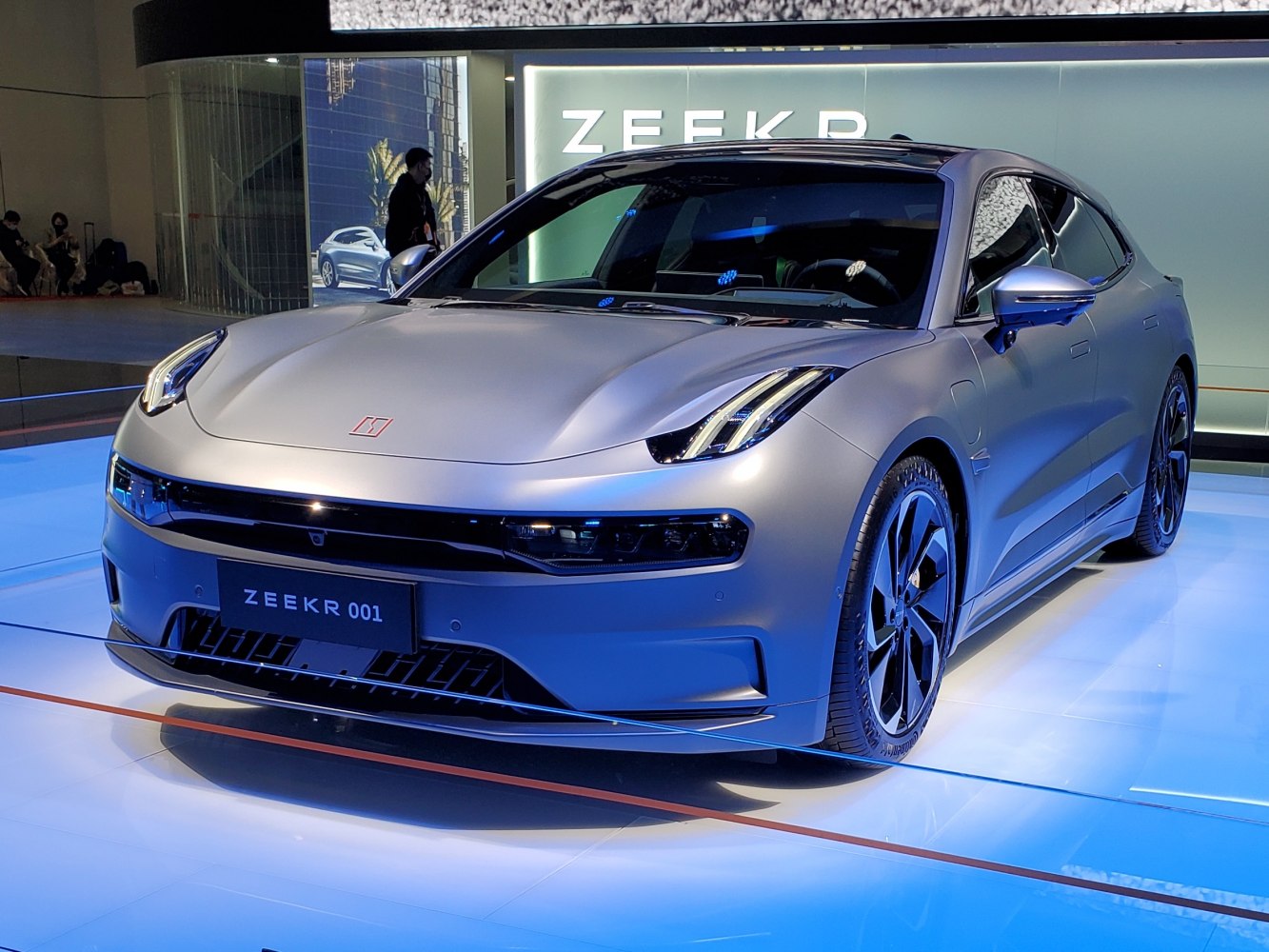 Front view of electric sedan with sleek headlights and modern wheels