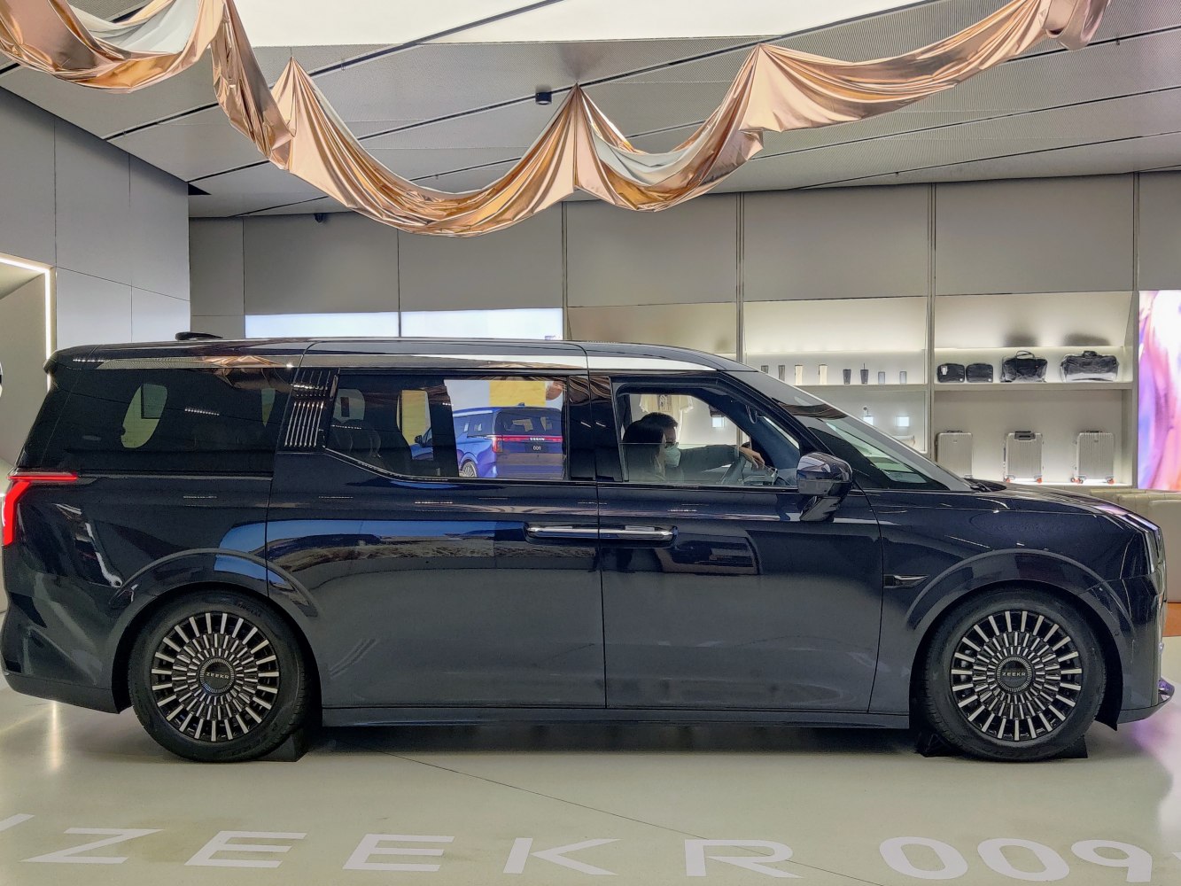 Electric MPV with luxury alloy wheels and sleek side profile