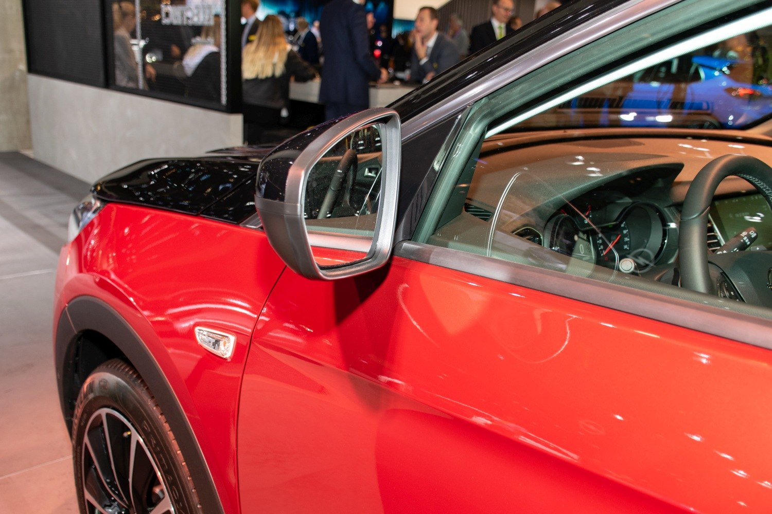 Close-up of side mirror, front side panel, and interior dashboard