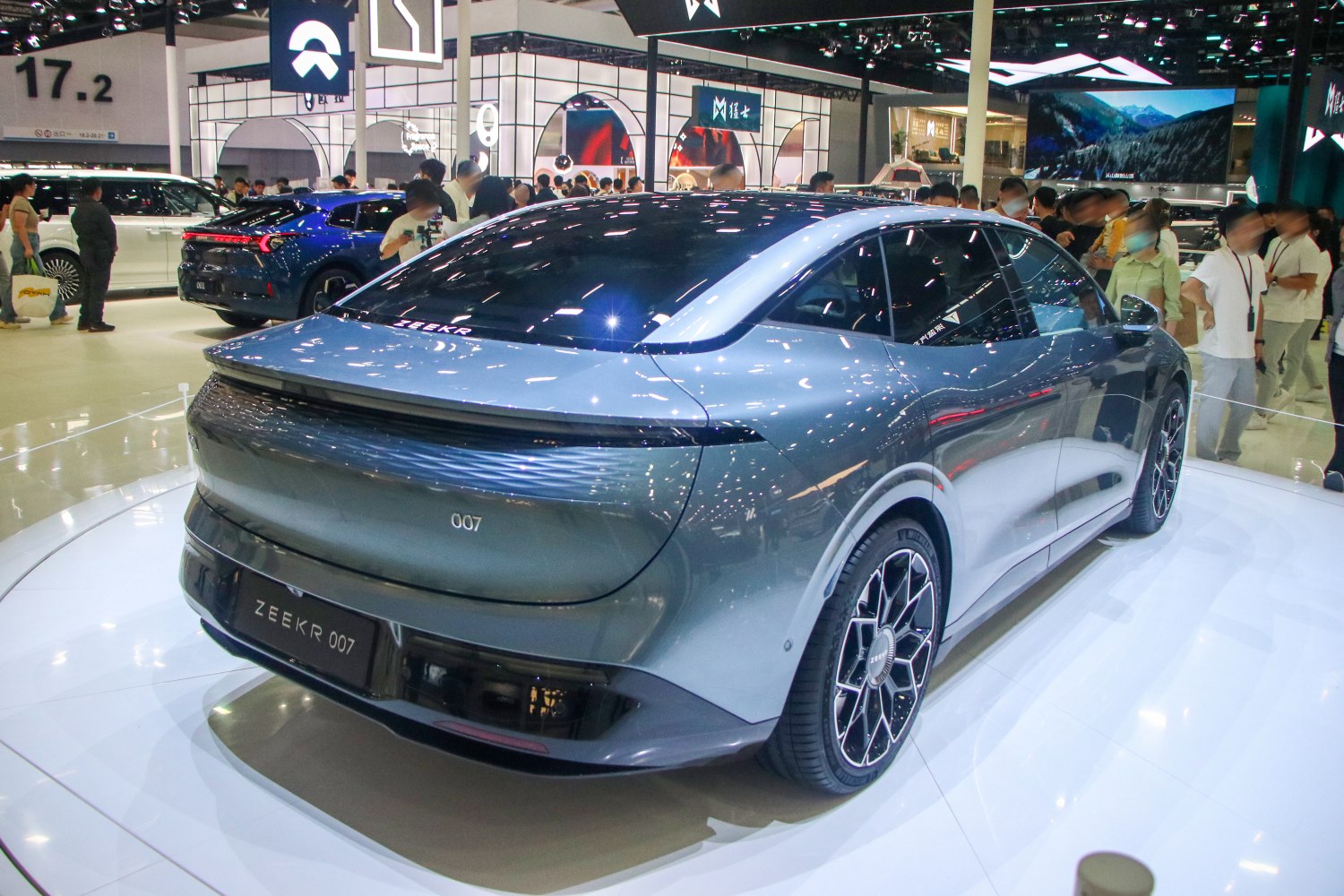Sleek electric sedan rear with continuous LED tail light bar and aerodynamic design.