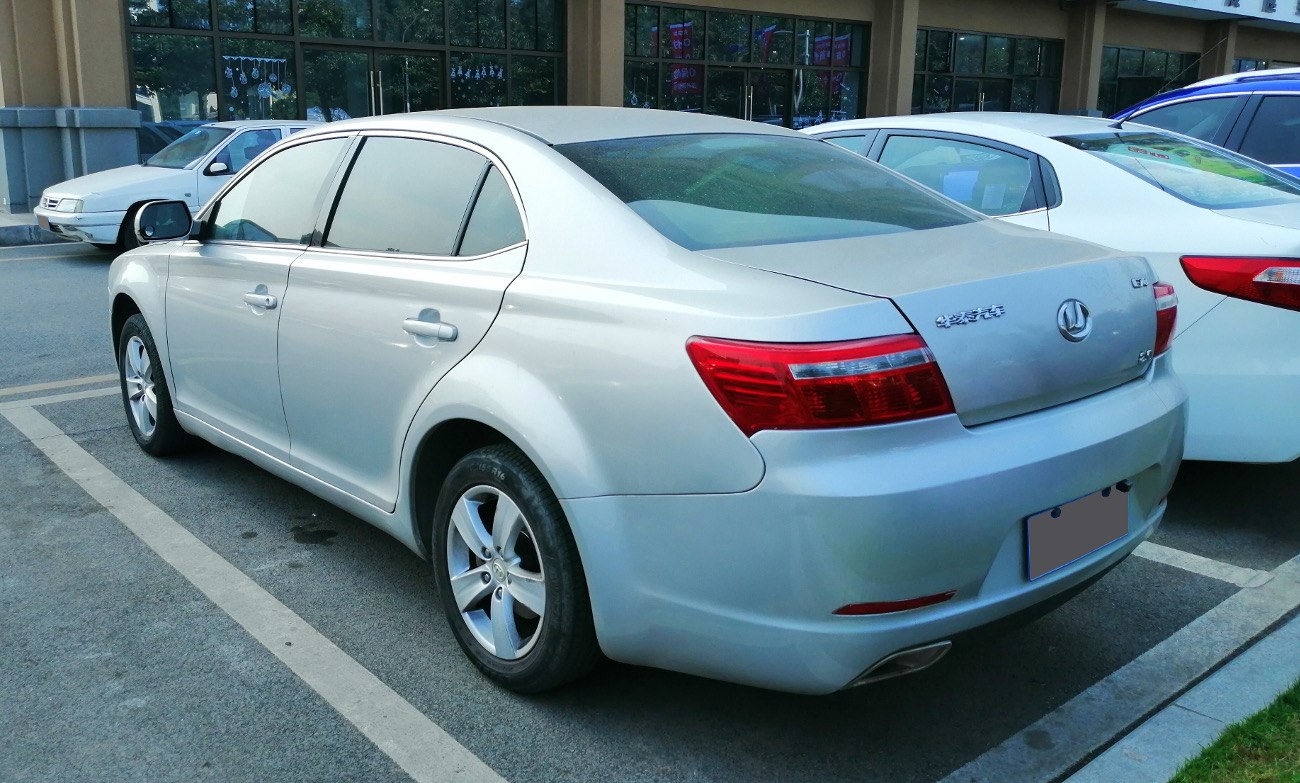 Rear profile of silver sedan with distinct taillights and exhaust pipe