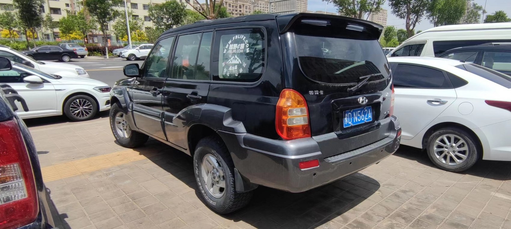 Black SUV with rear and side visible, off-road style features and tinted windows