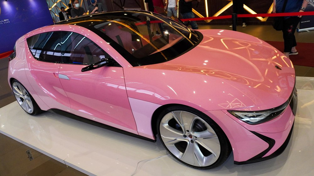 Sleek pink modern hatchback with sharp headlights and aerodynamic curves