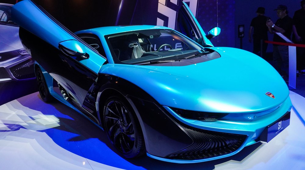 Blue electric sports car with open scissor doors and aerodynamic styling