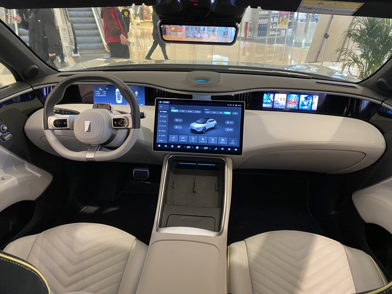 Digital cockpit with large touchscreen center console and modern steering wheel