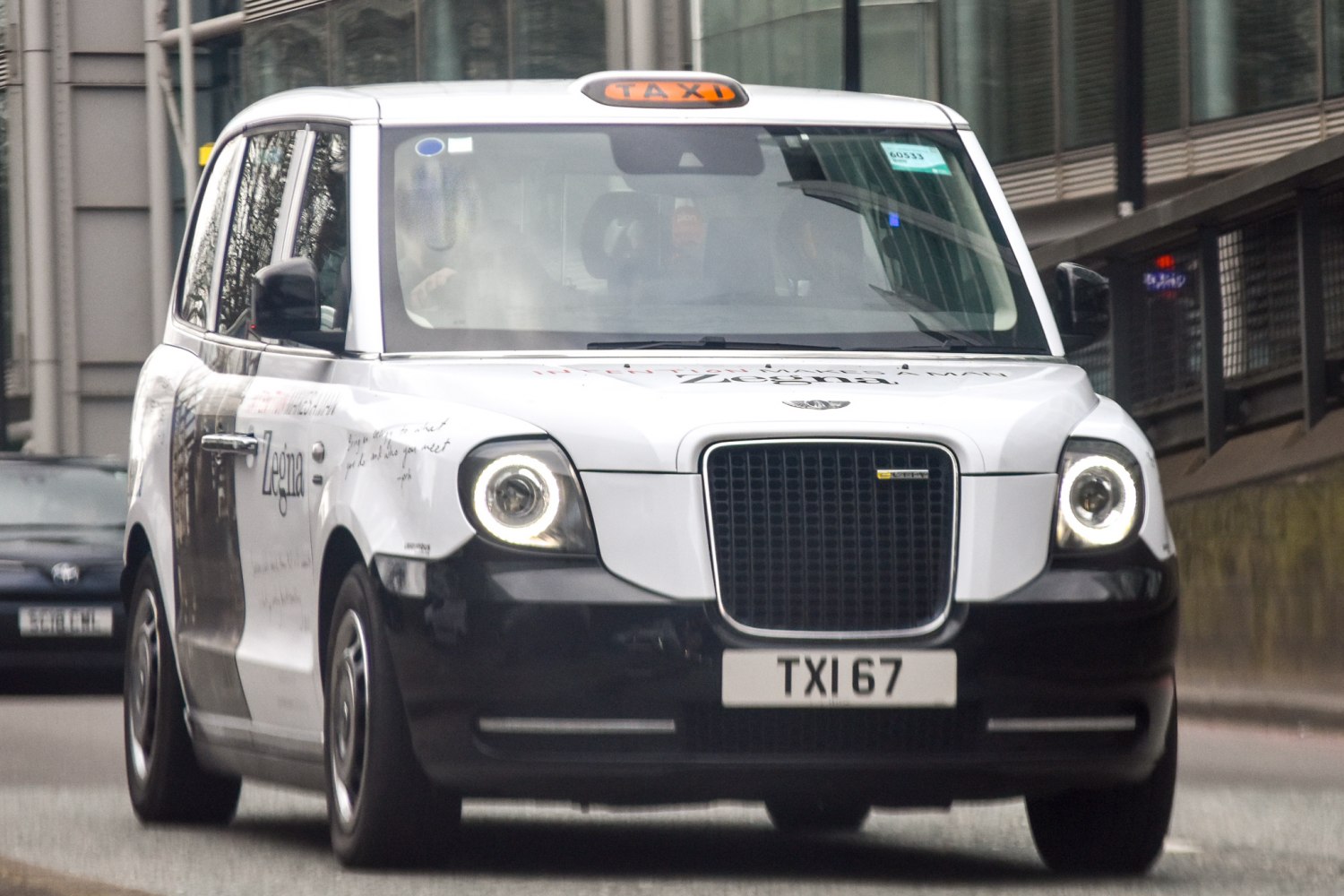 Front view of electric London taxi with circular LED headlights and taxi roof sign