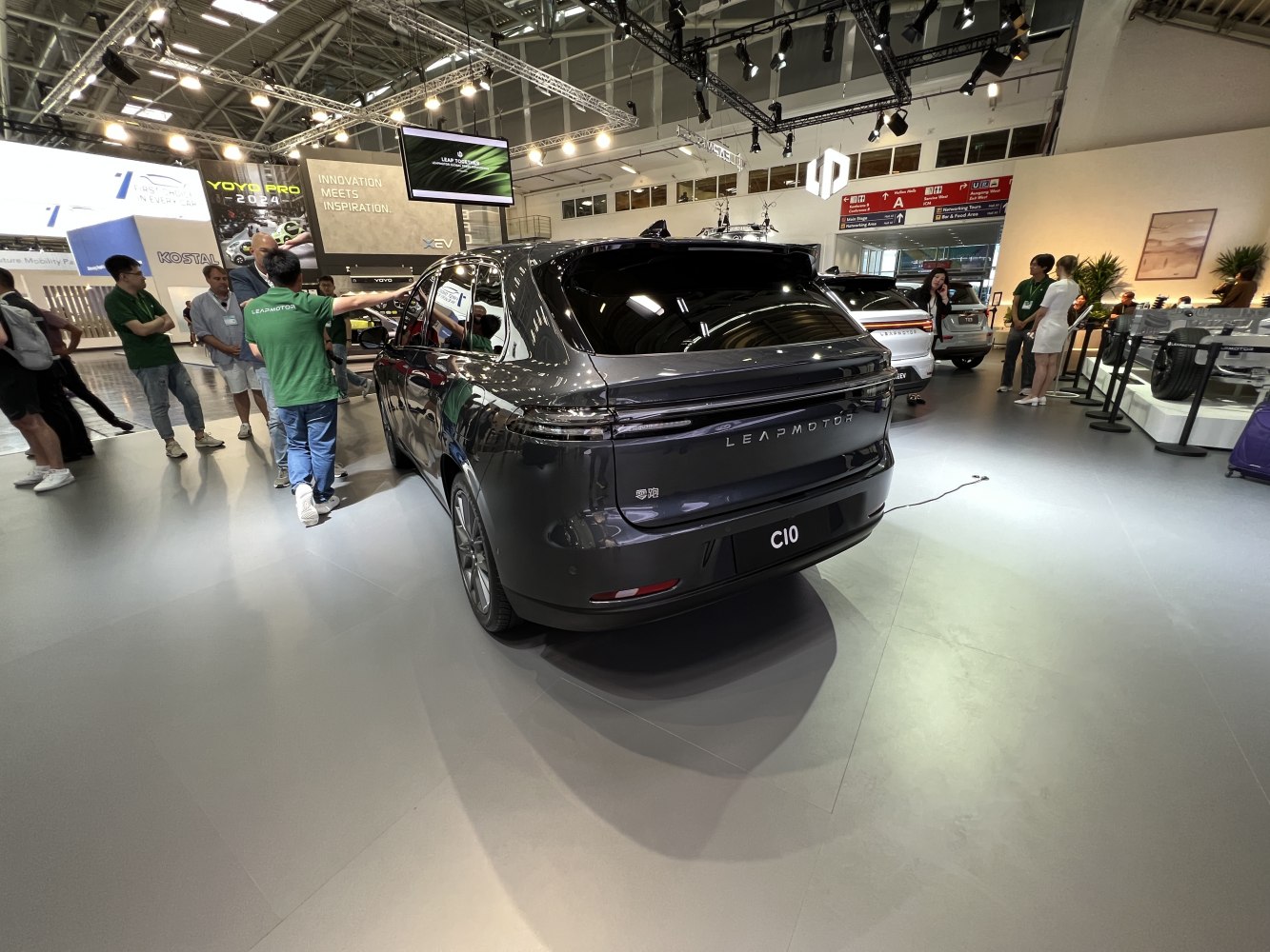Rear view of a sleek black electric SUV with continuous LED light bar and modern taillights.
