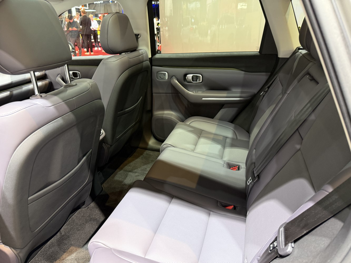 Spacious rear seats with modern door panel and seatbelt detail