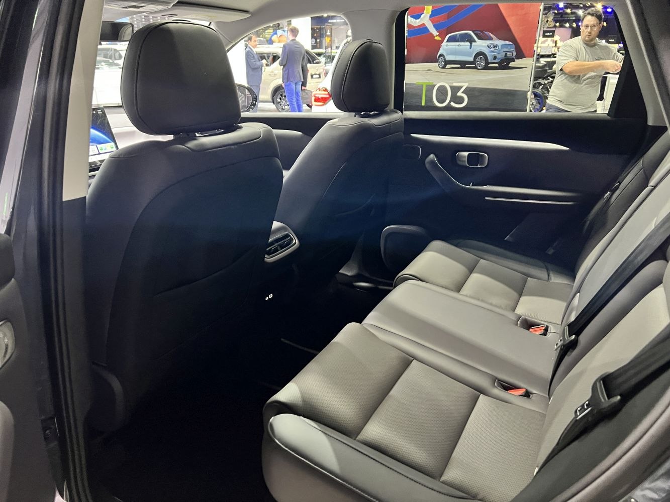 Rear seat interior with black upholstery and rear air vents.