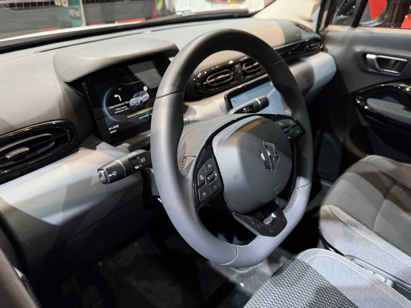 Steering wheel with control buttons and digital dashboard display
