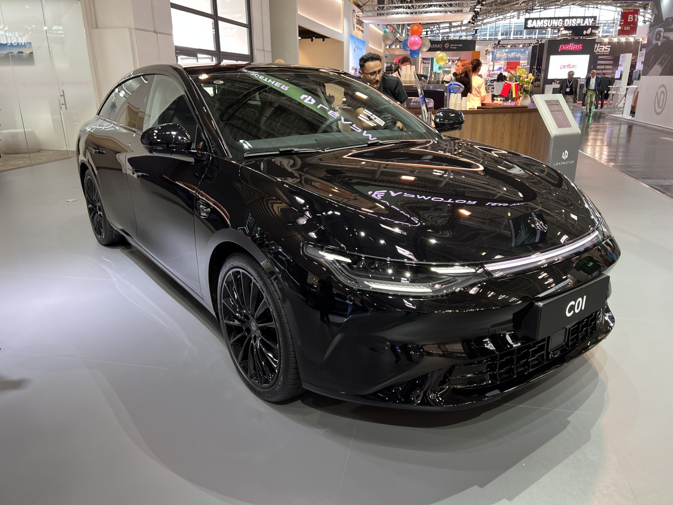 Black sleek electric sedan with modern aerodynamic design and distinctive headlights