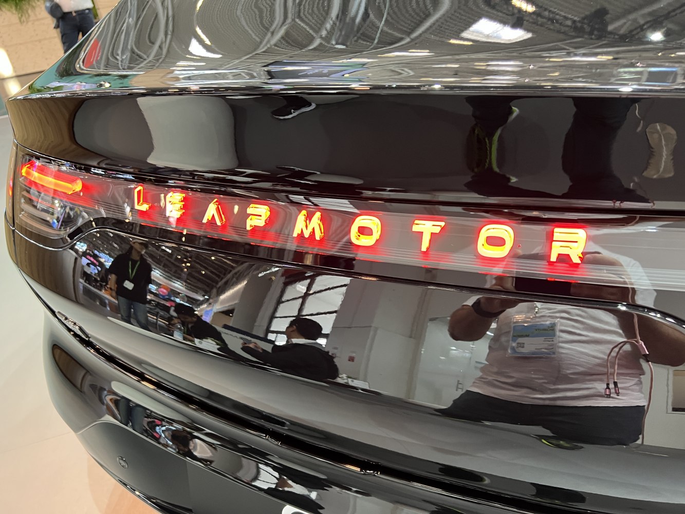 Illuminated rear LED tail light and LEAPMOTOR logo on glossy black surface