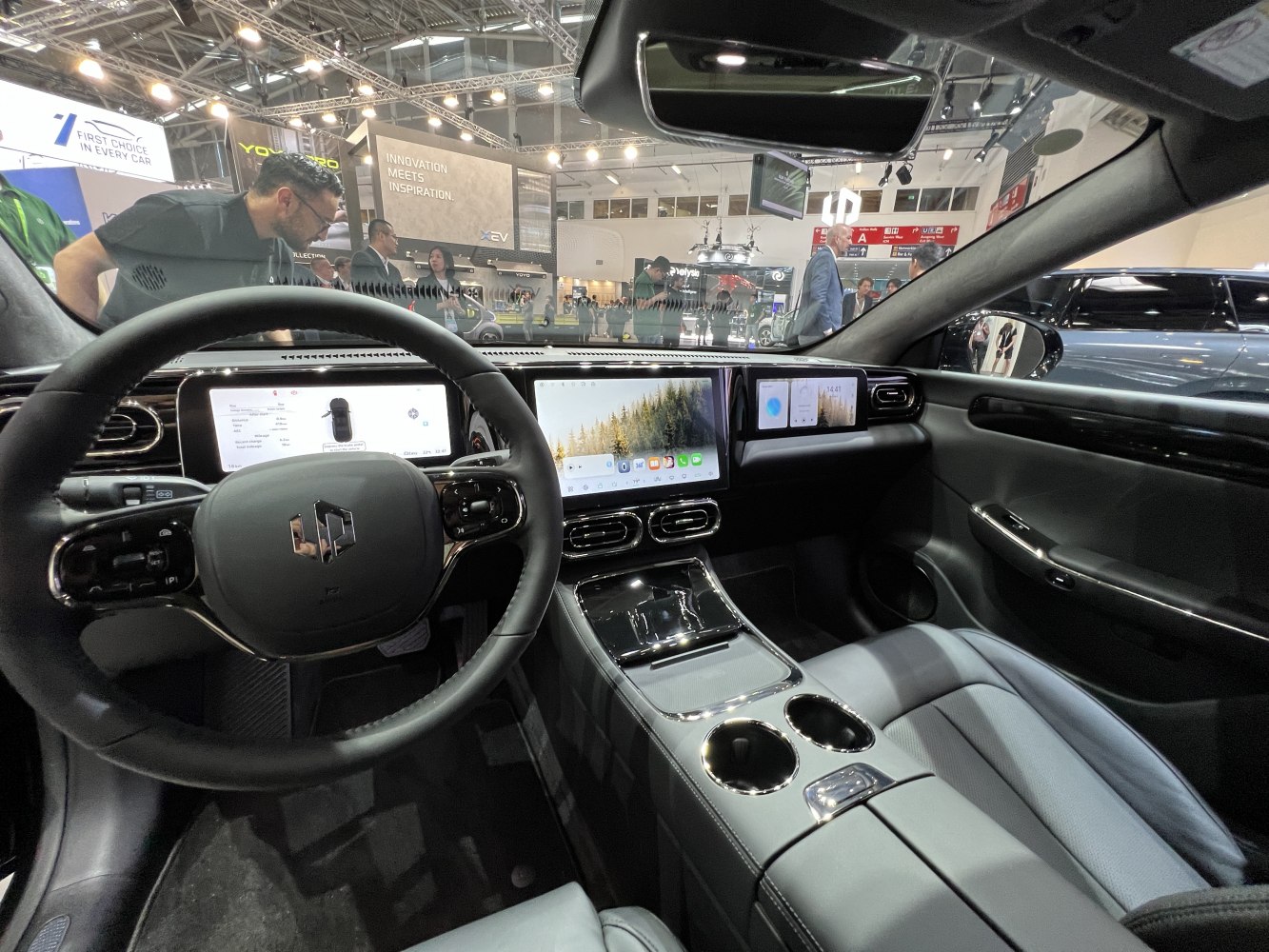 Modern dashboard with triple digital displays and sleek steering wheel